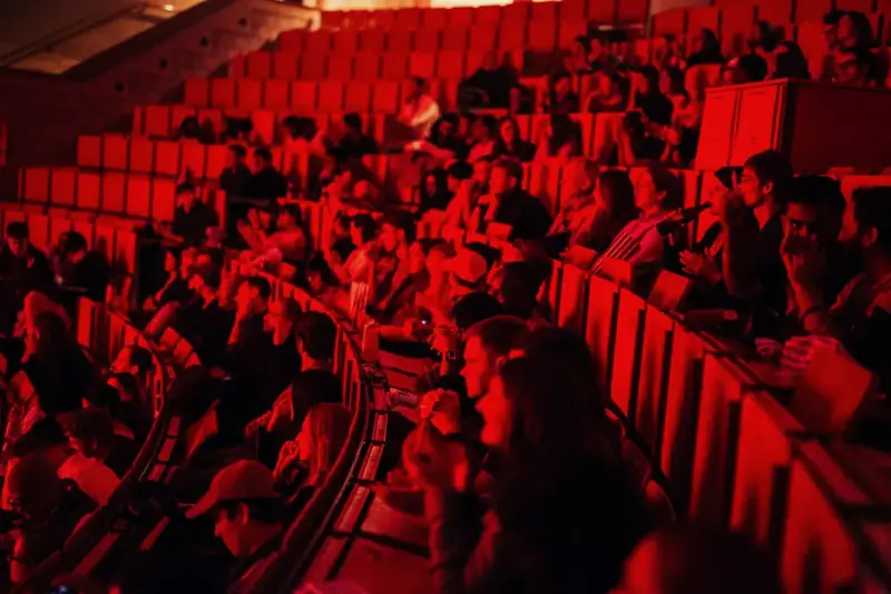 A Movie Sprint audience in a cinema lit deep red